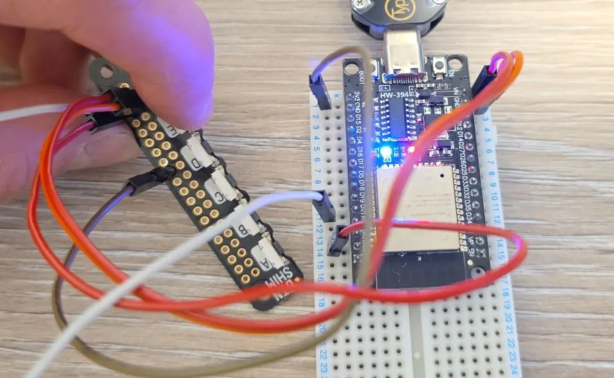 Photo of the button shim with button E pressed and built in LED on